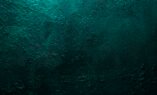 Deep emerald green texture or background with stains, waves and grain elements. Image with place for text. Template for design, banner